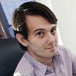 Activists holding signs with Turing CEO Martin Shkreli?s picture targeted  his offices in a recent drug-price protest.