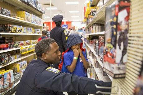 An officer and a child picked out items together. 
