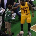 epa05070561 Cleveland Cavaliers forward LeBron James greets a young Boston Celtics fans during a break in the action during the first half of the game between Boston Celtics and the Cleveland Cavaliers at the TD Garden in Boston, Massachusetts, USA, 15 December 2015. EPA/CJ GUNTHER CORBIS OUT