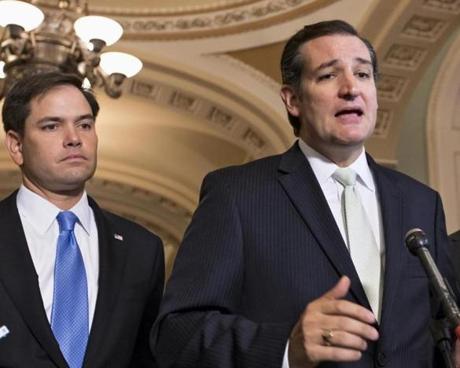 FILE - In this Sept. 27, 2013 file photo, Sen. Ted Cruz, R-Texas, right, accompanied by Sen. Marco Rubio, R-Fla., speaks on Capitol Hill in Washington. Republican presidential rivals Rubio and Cruz are backpedaling furiously as they try to outmaneuver each other on immigration. Rubio co-wrote a massive 2013 immigration bill that passed the Senate. He disavows it now, but Cruz won?t stop talking about it. (J. Scott Applewhite/Associated Press)
