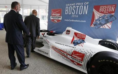 City of Boston Chief of Economic Development John Barros (right) and Tourism, Sports and Entertainment director Ken Brissette (left) examined an IndyCar mock-up following a news conference in Boston. 
