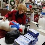 Rita Mae Cushman, of Dedham, buys a pair of blow mold snow people and boxes of lights at The Christmas Place in Abington. Craig F. Walker/Globe Staff