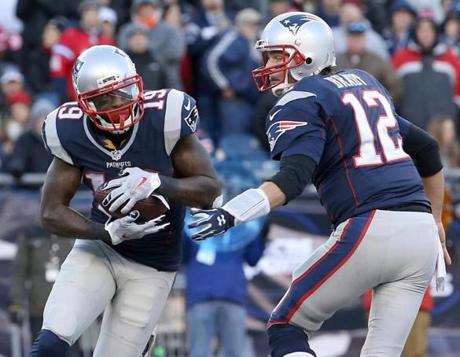 New England Patriots Tom Brady handed off to Brandon LaFell on an end around against the Tennessee Titans during fourth quarter action at Gillette Stadium. 
