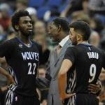 Minnesota Timberwolves interim head coach Sam Mitchell speaks with guard Andrew Wiggins (22) and guard Ricky Rubio (9), of Spain, during the third quarter of an NBA basketball game against the Denver Nuggets Tuesday, Dec. 15, 2015, in Minneapolis. The Nuggets won 112-100. (AP Photo/Hannah Foslien)