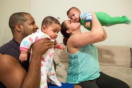 Carlos Oliveira and Adma Rodrigues with their 5-month-old twins, Lauren (left) and Luan.
