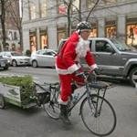 Jimmy Rider pedaled through Boston toward Copley Square with a Christmas tree in tow. Rider has delivered 200 trees this season.