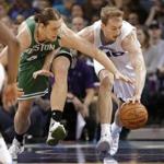 Charlotte Hornets' Cody Zeller, right, and Boston Celtics' Kelly Olynyk, left, chase the ball in the first half of an NBA basketball game in Charlotte, N.C., Wednesday, Dec. 23, 2015. (AP Photo/Chuck Burton)