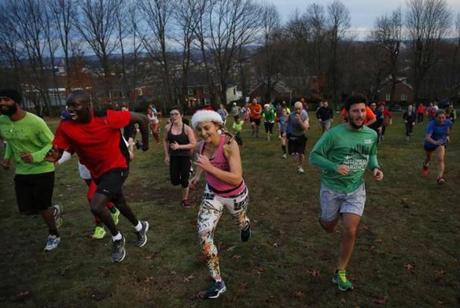 Members of The November Project sprinted uphill on Summit Avenue in Brookline on Christmas morning.
