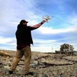 Kevin Ham from Force 4 Photography LLC grabs his drone after it flew along the Scituate coastline near Third Cliff in Scituate. Photo by Debee Tlumacki for the Boston Globe