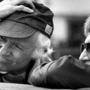 In this March 1983 photo, cinematographer Haskell Wexler adjusted his cap as he and director Blake Edwards (right) looked over a wall during the filming of 