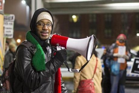Nino Brown speaks into a megaphone during a Justice for Tamir Rice protest at Jackson Square MBTA station in Roxbury on Tuesday, December 29. (Scott Eisen for The Boston Globe)
