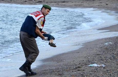 A Turkish police officer carries a migrant child's dead body off the shores in Bodrum, southern Turkey, on Sept. 2  after a boat carrying refugees sank while reaching the Greek island of Kos. Thousands of refugees and migrants arrived in Athens as Greek ministers held talks on the crisis, with Europe struggling to cope with the huge influx fleeing war and repression in the Middle East and Africa.
