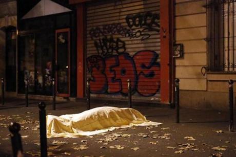 A victim of a terrorist attack lies dead outside the Bataclan theater in Paris, Nov. 13. 
