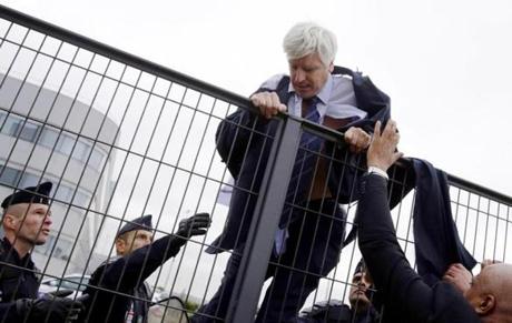 Director in charge of human resources of Air France long-haul flights, Pierre Plissonnier, nearly shirtless, is helped by security and police officers to climb over a fence, after several hundred employees stormed into the offices of Air France, interrupting the meeting of the Central Committee (CCE) in Roissy-en-France, on Oct. 5. Air France-KLM unveiled a revamped restructuring plan that could lead to 2,900 job losses after pilots for the struggling airline refused to accept a proposal to work longer hours. 
