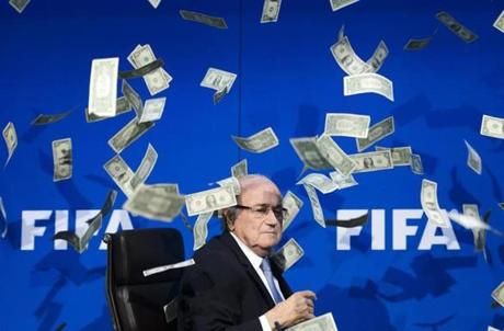 FIFA president Sepp Blatter looks on as fake dollar notes fly around him, thrown by a British comedian during a press conference at the FIFA world-body headquarter's on July 20 in Zurich. The 79-year-old Swiss official looked shaken as the notes thrown by Simon Brodkin, stagename Lee Nelson, fluttered around him in a conference hall at the FIFA headquarters. Brodkin was taken away in a Swiss police car after the stunt.
