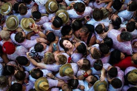 Revelers enjoy the atmosphere during the opening day or 'Chupinazo' of the San Fermin Running of the Bulls fiesta on July 6 in Pamplona, Spain. The annual Fiesta de San Fermin, made famous by the 1926 novel of US writer Ernest Hemmingway entitled 'The Sun Also Rises', involves the daily running of the bulls through the historic heart of Pamplona to the bull ring. 
