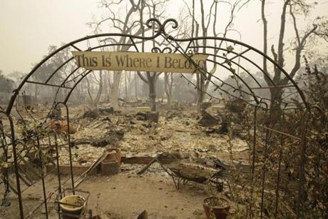A sign hangs above an entryway to a home destroyed by fire in Middletown, Calif., on Sept. 13. Gov. Jerry Brown's administration estimates it will cost at least $243 million to clean up and remove debris left in the wake of two major Northern California wildfires this fall. 
