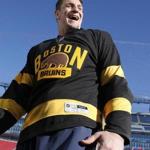 New England Patriots' tight end Rob Gronkowski wears a Boston Bruins jersey at Gillette Stadium in Foxborough, Mass., Thursday, Dec. 31, 2015, where the Bruins will play the Montreal Canadiens in the NHL Winter Classic outdoor hockey game on New Year's Day. (AP Photo/Michael Dwyer)