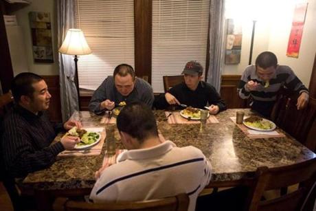(Clockwise from left to right) Residents Francis Chan, Wei -Li Sun, Joseph Wong, Donald Lee, and Wayne Wang ate their meal together at the group home. 

