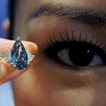 A model holds a 'De Beers Millennium Blue Diamond' with a Sotheby's pre-auction estimate of 4.6-5.9 million USD, in Hong Kong on March 18, 2010. Sotheby's will hold a jewel and jadeite 2010 spring sale on April 7. AFP PHOTO/MIKE CLARKE (Photo credit should read MIKE CLARKE/AFP/Getty Images)