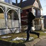 Somerville, Massachusetts -- 1/3/2016- Boston Globe reporter Steve Annear ran up to a porch to drop off a paper as he and other Globe journalists worked to deliver the Sunday Boston Globe in Somerville, Massachusetts January 3, 2016. Jessica Rinaldi/Globe Staff Topic: Reporter: 