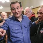 Republican Presidential candidate, Sen. Ted Cruz, R-Texas talks to a reporter while standing with supporter Court Oviatt of Logan, Iowa, after a campaign speech at the public library in Onawa, Iowa, Tuesday, Jan. 5, 2016. (AP Photo/Nati Harnik)