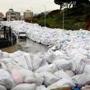 A van drove past piles of wrapped garbage blocking a road in the town of Jdeideh, northeast of Beirut, on Monday.