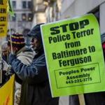 Protesters gathered Monday near the steps of the courthouse in Baltimore where a Maryland appeals court postponed the trial of a van driver charged with second-degree murder in the death of Freddie Gray.