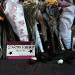 Flowers, candles, and pictures comprise a memorial set up Monday outside David Bowie?s New York apartment. 