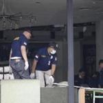 Police officers examined a damaged Starbucks cafe after attackers struck Jakarta, Indonesia. 