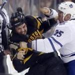 Boston?s Zac Rinaldo (left) and Toronto?s Rich Clune have at it during the first period Saturday night. 