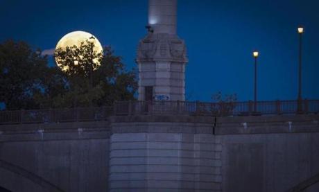 A full moon makes rises next the Springfield Memorial Bridge in downtown Springfield, Massachusetts. The bridge was constructed in 1922 and spans 209 feet. (Steven G Smith for The Boston Globe)
