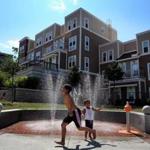 Children played in a fountain in the Box District, a newly redeveloped area near Bellingham Square in Chelsea.
