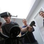 The author tried out a virtual workout with guidance from VirZOOM?s Eric Janszen (center) and Eric Malafeew.