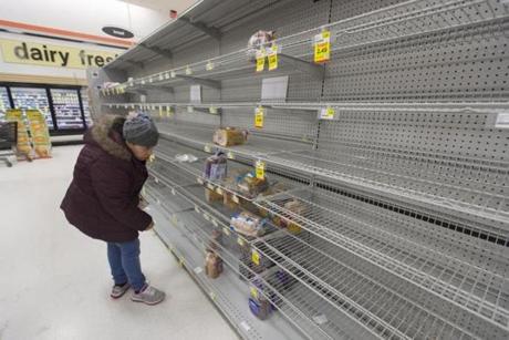 A customer looked at the heavily depleted bread section of a grocery store, as shoppers prepare for an approaching snowstorm in Alexandria, Virginia on Wednesday.
