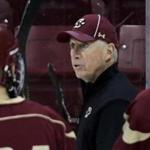 FILE - In thi Dec. 5, 2012, file photo, Boston College hockey coach Jerry York, center, talks with his players during an NCAA college hockey practice in Boston. York goes for the 1,000th victory of his career on Friday, Jan. 22, 2016, when the BC Eagles play the University of Massachusetts. (AP Photo/Charles Krupa, File)