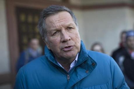 Republican presidential candidate John Kasich spoke with a reporter following an impromptu meeting with volunteers at a restaurant  in Laconia, N.H. on Thursday. 
