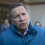 Republican presidential candidate John Kasich spoke with a reporter following an impromptu meeting with volunteers at a restaurant  in Laconia, N.H. on Thursday. 