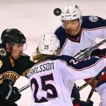 Boston-01/23/16- The Boston Bruins vs the Columbus Blue Jackets. Bruins Brad Marchand chases after a bouncing puck with Blue Jackets William Karlsson and Seith Jones(rt) in the 1st period. Boston Globe staff photo by John Tlumacki(sports)