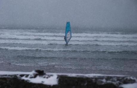A surfer took to the waters off Newport, R.I., during Saturday?s storm.
