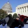 People sledded down the snow on the hill below the US Capitol.
