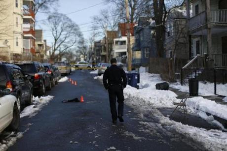 A police officer walked down Nightingale Street, where a man was shot in the stomach over a parking space Monday. 
