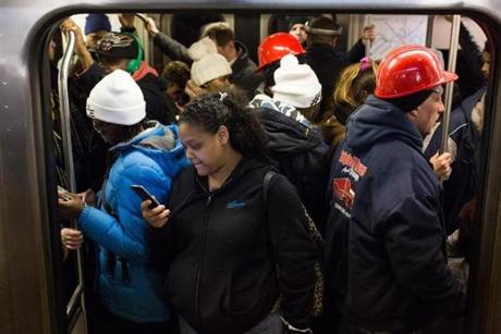Commuters crammed into a Red Line train at South Station on Monday. 
