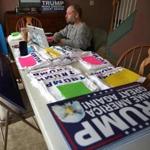 George Lambert, town chair for Donald Trump in Litchfield, N.H., organized T-shirts and signs as he called voters from his home Tuesday.