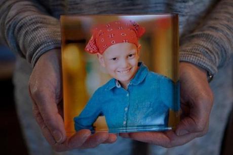 Paula Skelley displays a photograph of her daughter Lydia Valdez, seen here at age 8, who died a year later, in 2013.
