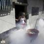 A woman covered her mouth and nose during a fumigation campaign at the Petare slum in Caracas, Venezuela, to help control the spread of the mosquito-borne Zika virus.
