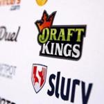 A DraftKings logo is displayed on a board inside of the DFS Players Conference in New York last fall.