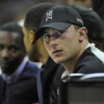 Cleveland Browns quarterback Johnny Manziel watches a Cleveland Cavaliers and Dallas Mavericks basketball game in Cleveland, Ohio, in this file photo taken October 17, 2014. Manziel's ex-girlfriend told police he hit her after they met friends at a Dallas hotel and again when they were driving back to her home in Fort Worth, according to a police report released on Thursday. Mandatory Credit: David Richard-USA TODAY Sports/Files