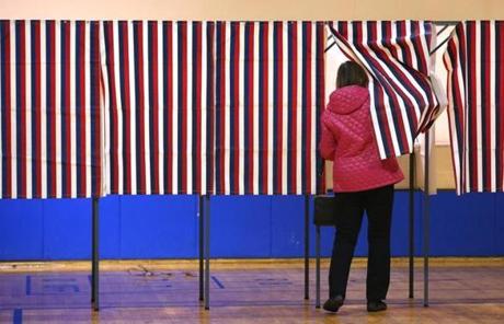A voter cast her ballot in a voting booth at Seabrook Community Center.
