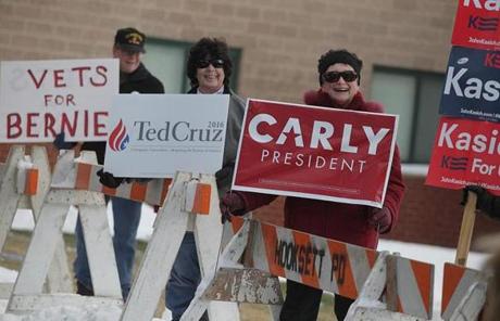 Supporters held signs outside the Cawley Middle School in Hooksett, N.H.

